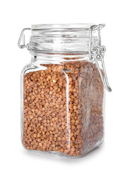 Jar with buckwheat grains on white background