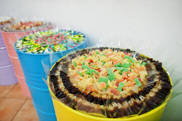 Barrels with sweets in candy shop.
