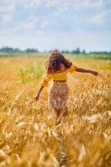 A happy caucasian young and beautiful woman in a field.