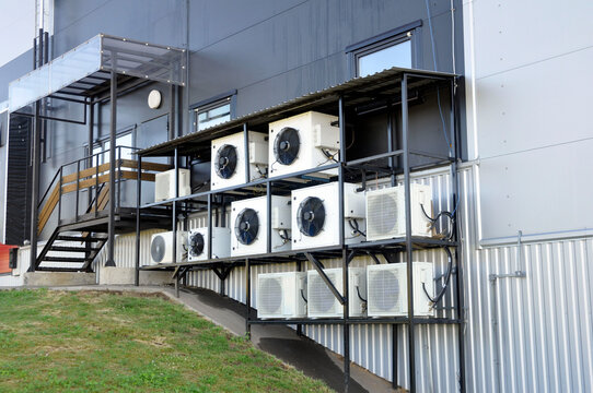 Air conditioning and heat pump. Split system on the wall of a modern industrial building.