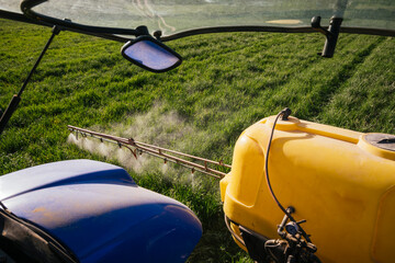 Crop sprayer spraying fertilizer on field