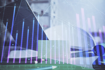 Stock market graph and table with computer background. Multi exposure. Concept of financial analysis.