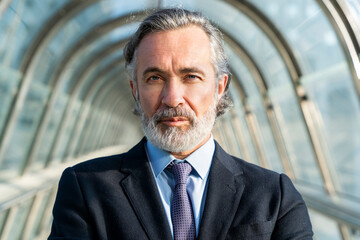 Businessman with gray hair on footbridge