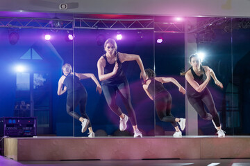Determined women practicing zumba in fitness studio
