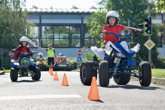 Boy riding quadbike on traffic course at traffic education training