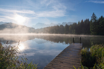 Germany, Bavaria, Geroldsee lake at foggy sunrise
