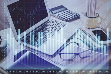 Forex market chart hologram and personal computer background. Multi exposure. Concept of investment.