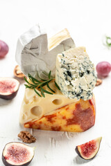 assortment of cheese, camembert, emmental, marble delicous cheese, blue cheese french, dorblu, mold, roquefort, Food recipe background. Close up
