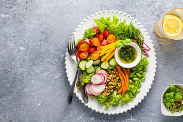 Healthy chopped salad with fresh vegetables, sprouts and sauce. Concept clean eating. Top view.