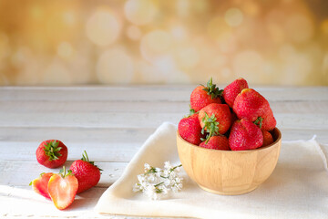 Fresh ripe red strawberries in wooden cup and whitecloth on  bokeh background, natural rustic food,fruit