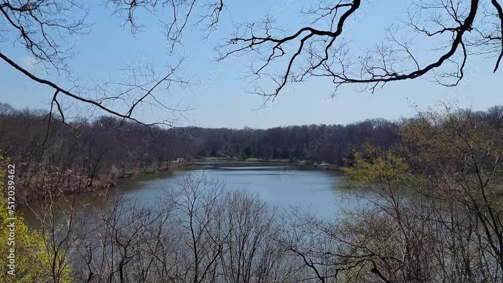 Poster Large Lake in Early Spring with Most Trees Bare but Some Starting To Bud with Blue Skies and Sweeps Left to Right.