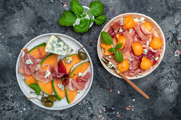 appetizer with sweet melon and ham, dorblu stilton dairy product, blue cheese roquefort gorgonzola,...