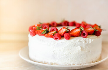 Delicious biscuit cake with cream cheese and berries. Light cake with strawberries and raspberries. Handmade cake. close up, copy space background