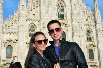 couple in leather in a front of Duomo di Milano - Milan Cathedral - Italy