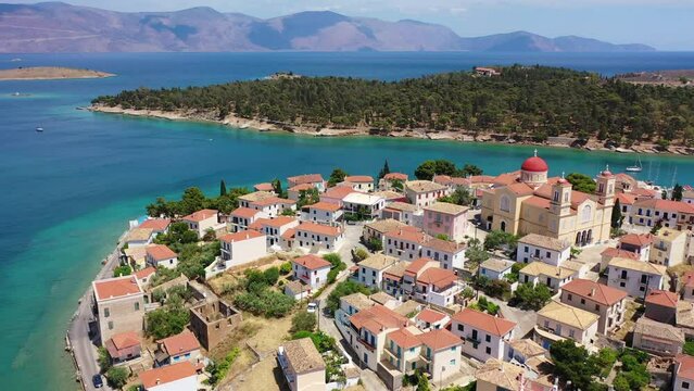 Aerial drone video from picturesque and traditional historic village of Galaxidi featuring landmark church of Agios Nikolaos, Fokida, Greece