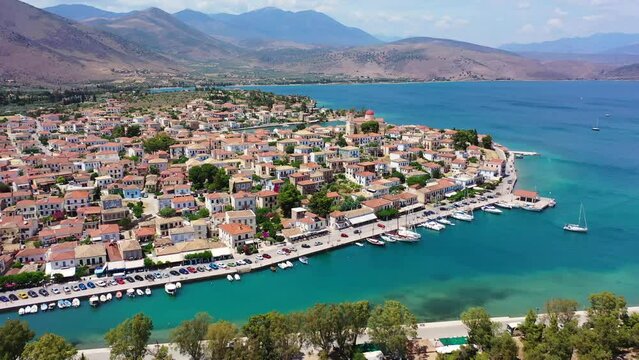 Aerial drone video from picturesque and traditional historic village of Galaxidi featuring landmark church of Agios Nikolaos, Fokida, Greece