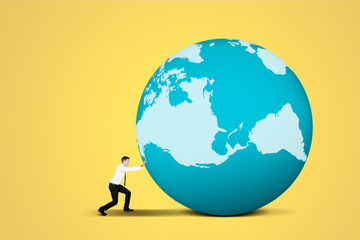 Businessman struggling to push a globe on studio