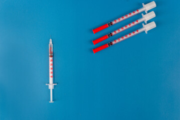 Medical syringes for insulin on a blue background. Diabetes