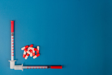 Medical syringes for insulin on a blue background. Diabetes