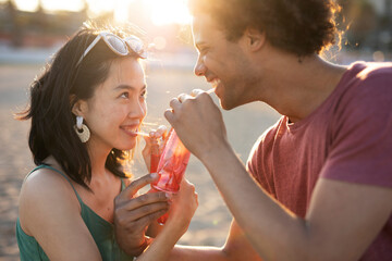 Beautiful young couple enjoy at the beach. Happy couple having fun at sea resort..