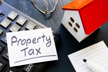 Property tax reminder on calculator and house model.