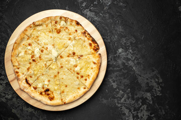 Italian food Delicious pizza Four Cheeses with cheddar, Parmesan, mozzarella on a dark background, banner, menu, recipe place for text, top view