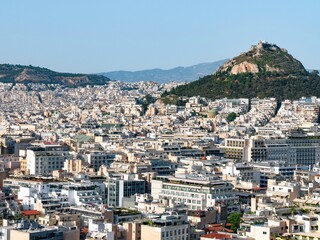 Fototapeta premium Panorama of Athens, Greece on a during golden hour with views on Philopappos Hill