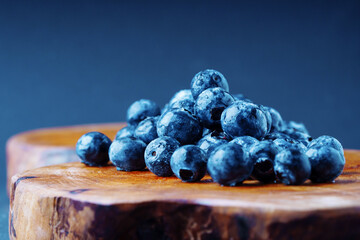Ripe blueberry on a wooden board. Close up view.