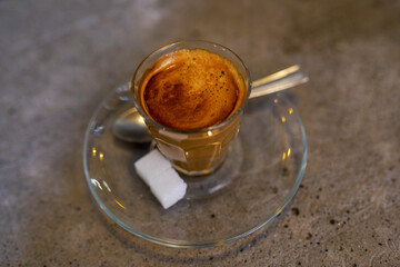 Cup of coffee on cocnrete table in the cafe