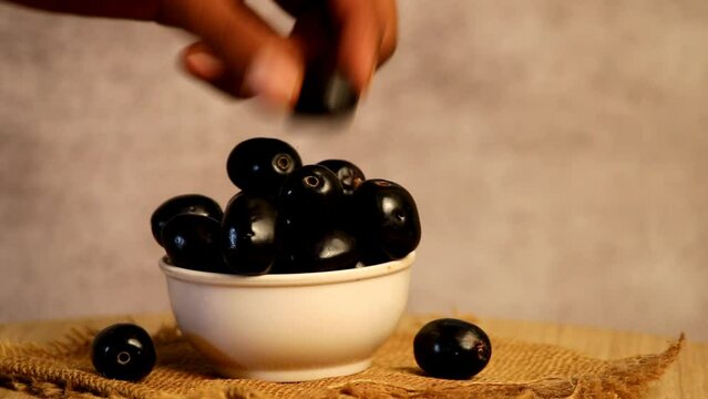 man pickup jamun fruits or blueberry, hand pickup berry, eatable berry ,fruity concept