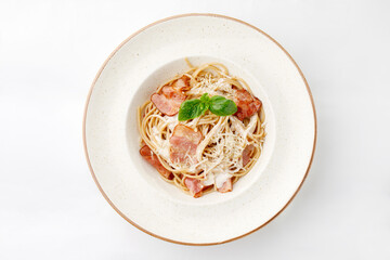 Pasta with parmesan bacon and white sauce on a white background