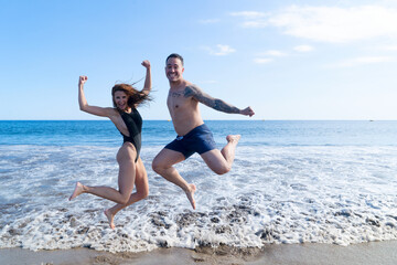 Fototapeta na wymiar Happy young couple at the sea vacations