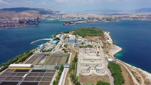 Aerial drone flyover video of small island of Psitaleia a latest technology industrial water sewage plant near Perama, Attica, Greece