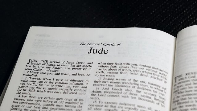 Close Up Shot of  Bible Page Turning to the book of Jude