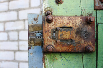 Old rusty lock on wooden door closeup