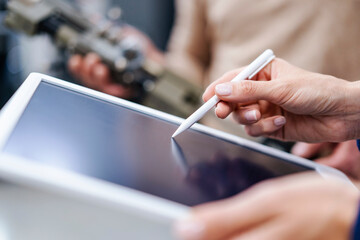 Close-up of businesswoman using digitized pen on tablet