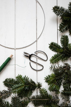 Making of wreath with wire, thread and spruce twigs