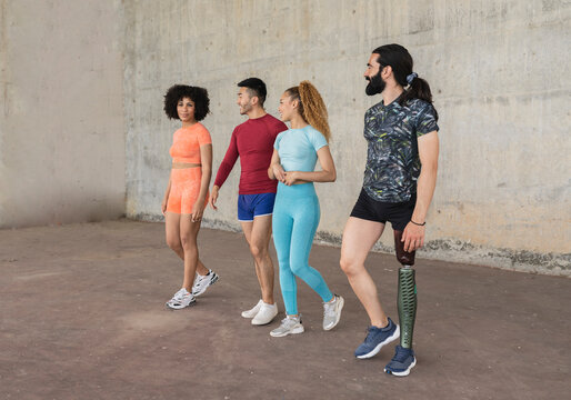 group of sporty multiracial friends in the city, disabled man with prosthesis leg Doing sport on the street