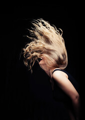 Happy blonde dancer woman profile with wind in long hair