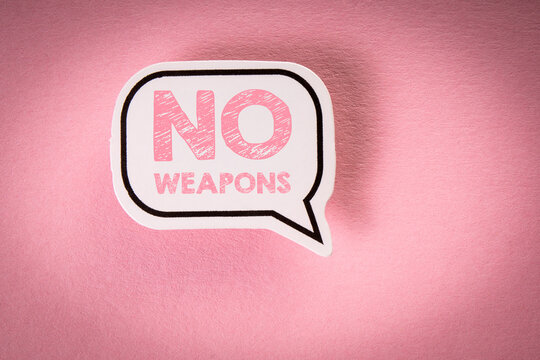 NO WEAPONS. Speech bubble with text on a pink background