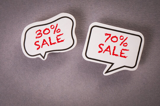 Shopping online (30 and 70 % sale). Two speech bubbles on a gray background