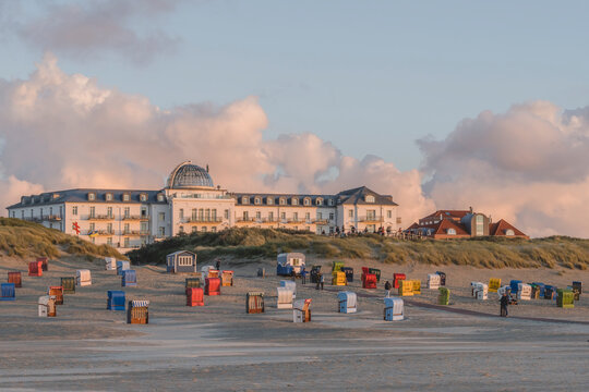 Germany, Lower Saxony, Juist, Hooded beach chairs in front of Strandhotel Kurhaus