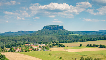Panoramic view over monumental Lilienstein sandstone pillars, an iconic table like mount at sunset...