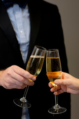 Cropped close-up toasting celebration two glasses with sparkling champagne wine in hands