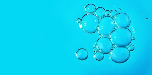 Close up macro Aloe vera gel serum cosmetic texture blue background with bubbles. Cruelty free. Lemongrass gel skincare product. antibacterial liquid with aloe vera, moisturizing.