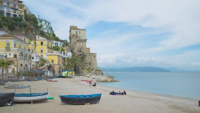Cetara, Italy. Time lapse video with panning effect of the beach of the old village of Cetara and old buildings and tower near the sea. May 6th, 2021.
