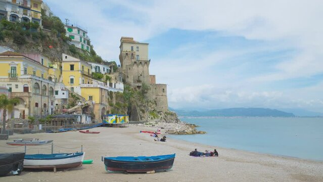 Cetara, Italy. Time lapse video with panning and zoom in effect of the beach of the old village of Cetara and old buildings and tower near the sea. May 6th, 2021.