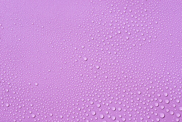 Liquid drops on a lilac background Natural sunshine and shadows. Skincare products. Beauty concept for face and body care in top view.