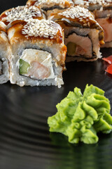 Colorful sushi with shrimp, cucumber, cream cheese. Next wasabi and soy sauce.