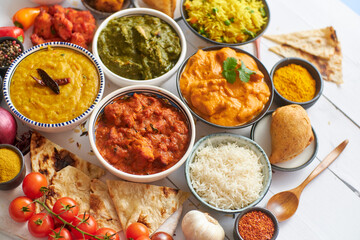 Assorted Indian various food with spices, rice and fresh vegetables